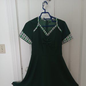 Green retro dress with plaid trim.